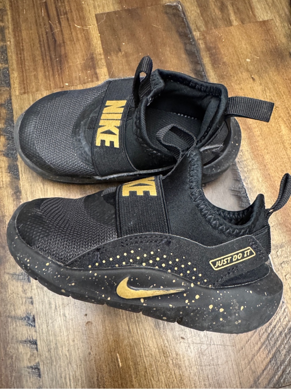 NIKE Kids Black and Gold Slip-On Sneakers